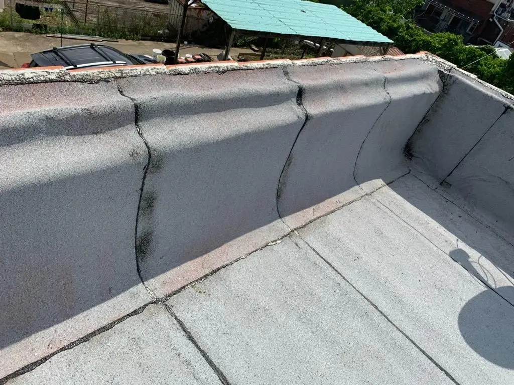 Parapet wall and flat roof edge on a Brooklyn rooftop
